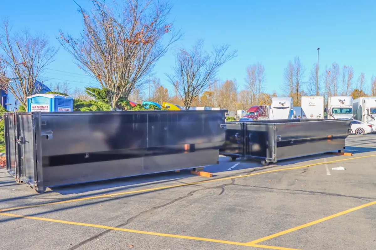 Professional dumpster rental service with roll-off container on residential driveway in Catonsville